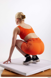 Unaisa  1 black sneakers dressed kneeling orange bike shorts…